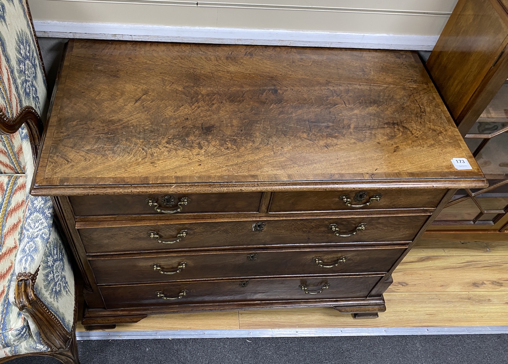 A George III mahogany and crossbanded chest, c.1760, the two short and three long drawers flanked by fluted pilaster corners, on ogee bracket feet, restored, width 105cm, depth 56cm, height 84cm